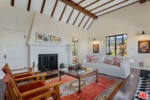 a living room with furniture a fireplace and a rug