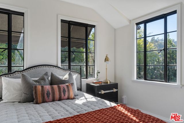 a bedroom with a large bed and a window