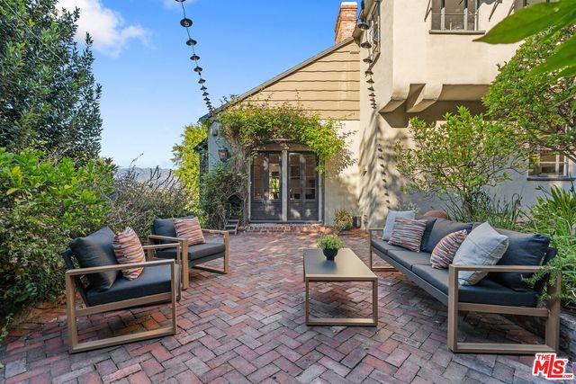 a backyard of a house with outdoor seating