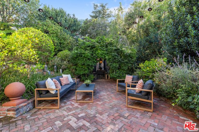 a backyard of a house with outdoor seating