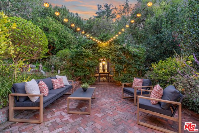 a backyard of a house with table and chairs