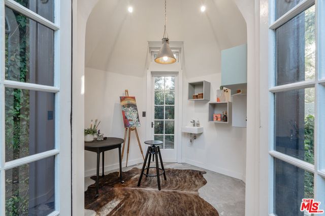 a swimming pool with outdoor seating and plants