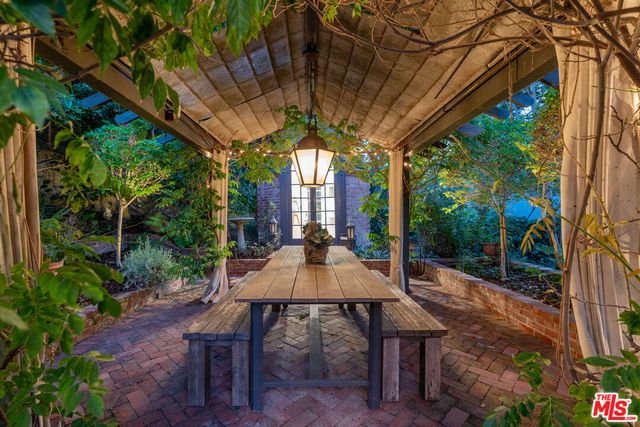 a view of a patio with couches table and chairs and potted plants