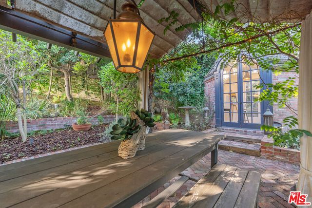 a front view of a house with yard and sitting area