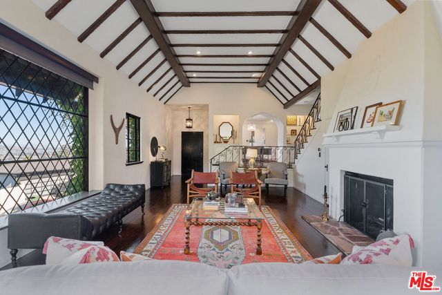 a living room with furniture or fireplace and a table