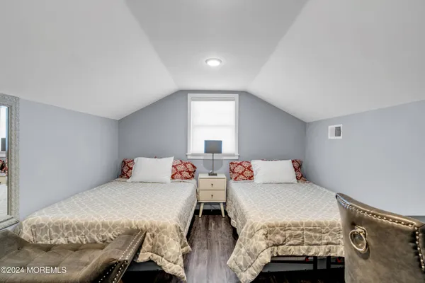 a bedroom with two beds and a window