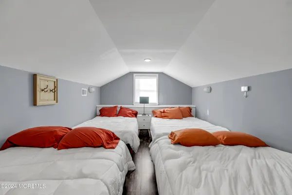 a bedroom with two beds and a window