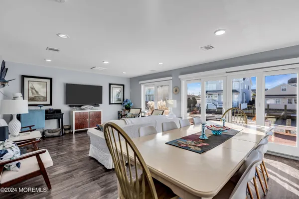 a living room with furniture a flat screen tv and a table
