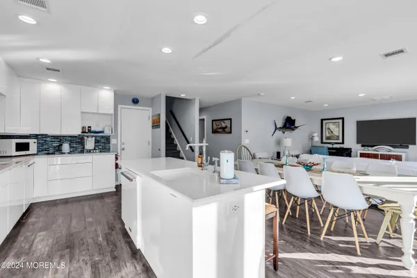 a large kitchen with a table and chairs