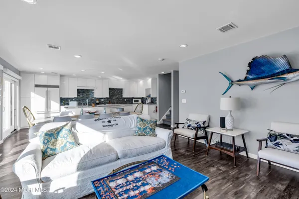 a living room with furniture kitchen view and a table