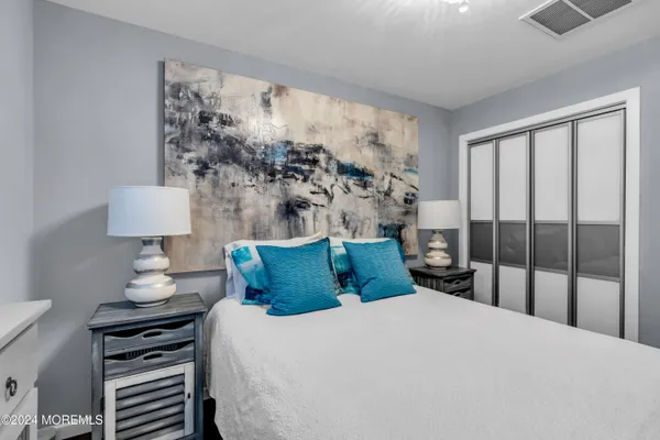 a bedroom with a bed and a night stand