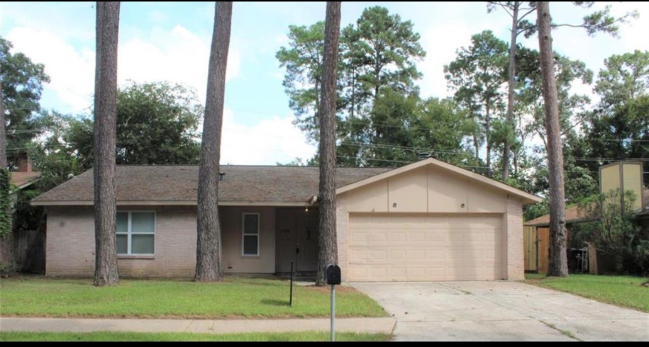 23022 Laketree Lane Spring, TX 77373 - Photo 1 of 42 a front view of a house with a yard and garage