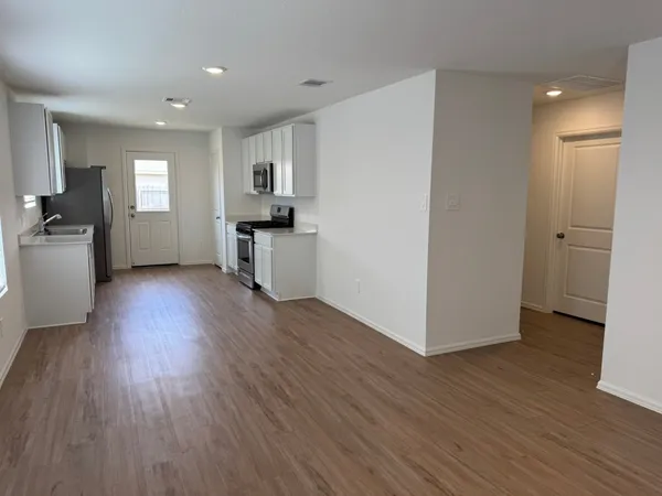 a view of a kitchen with a sink and a refrigerator