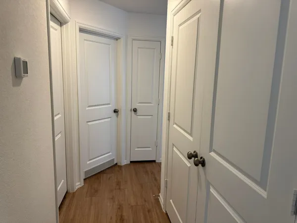 a view of a hallway with wooden floor