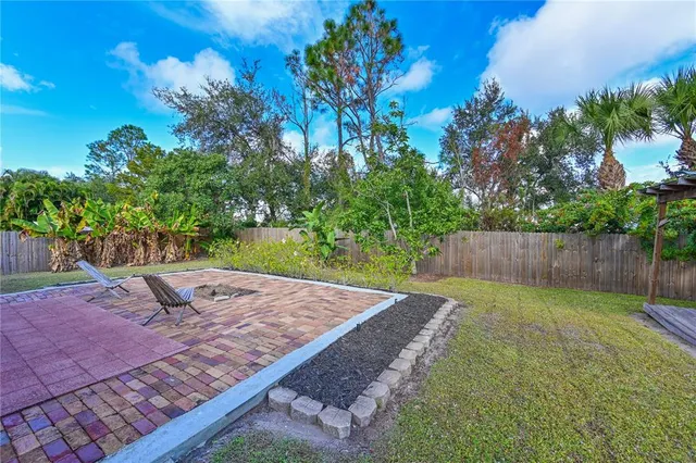 a view of a backyard with a tree