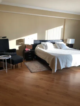 a spacious bedroom with a bed and a desk