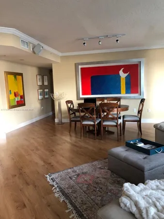 a living room with furniture pool table and a flat screen tv
