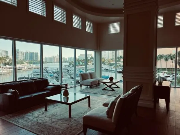 a living room with furniture and a floor to ceiling window