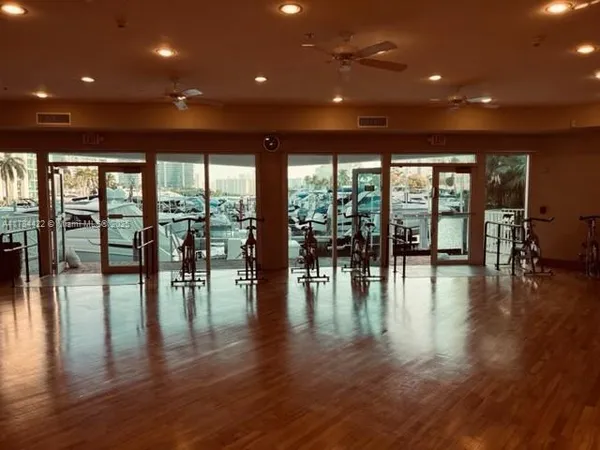 a view of empty room with wooden floor and floor to ceiling window