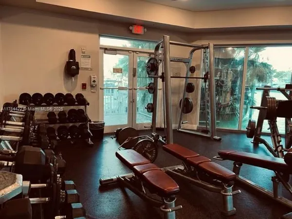 a room with gym equipment and a large window
