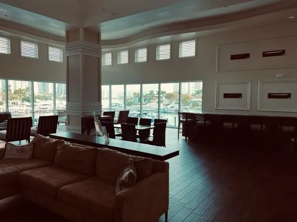 a living room with furniture and large windows