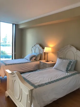 a bedroom with bed and window