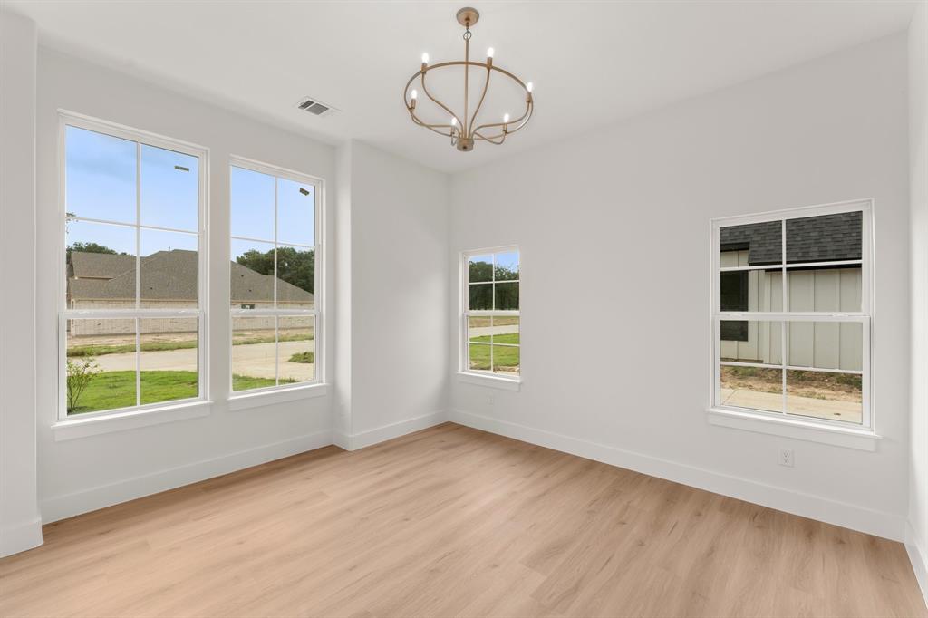 320 Dalton Road Canton, TX 75103 - Photo 22 of 29 Spare room with light wood finished floors and a chandelier