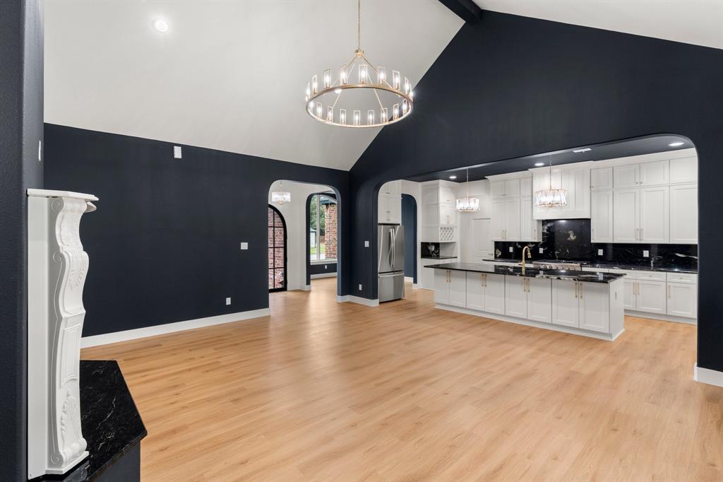 320 Dalton Road Canton, TX 75103 - Photo 5 of 29 Kitchen featuring arched walkways, a chandelier, decorative light fixtures, white cabinets, and decorative backsplash