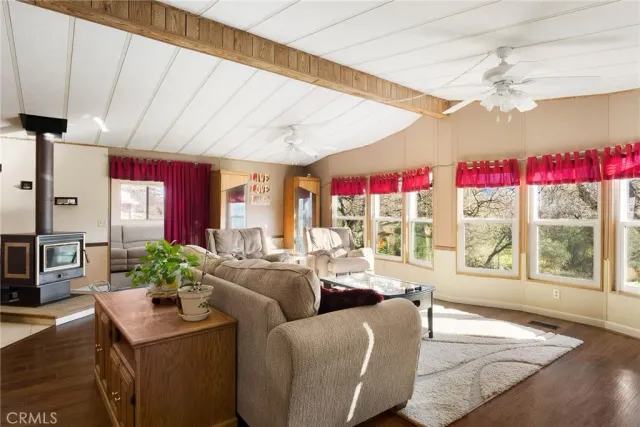 a living room with furniture a flat screen tv and a large window