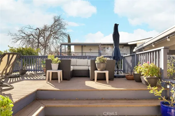 a view of a balcony with two chairs and a table