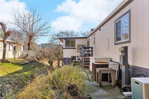 a view of a house with pool and sitting area