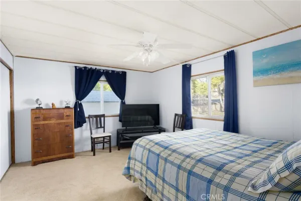 a bedroom with a bed table and window