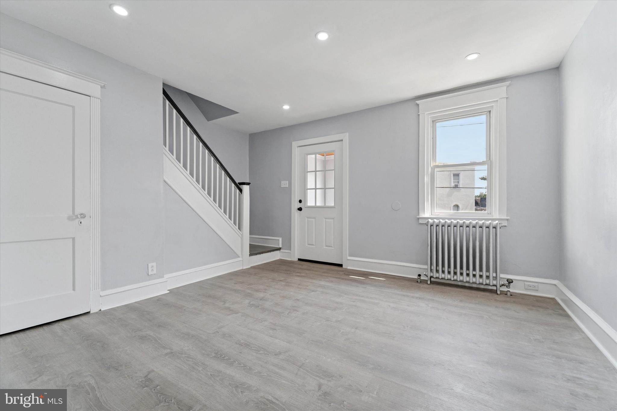 7139 Guilford Road Upper Darby, PA 19082 - Photo 4 of 14 wooden floor and windows in an empty room