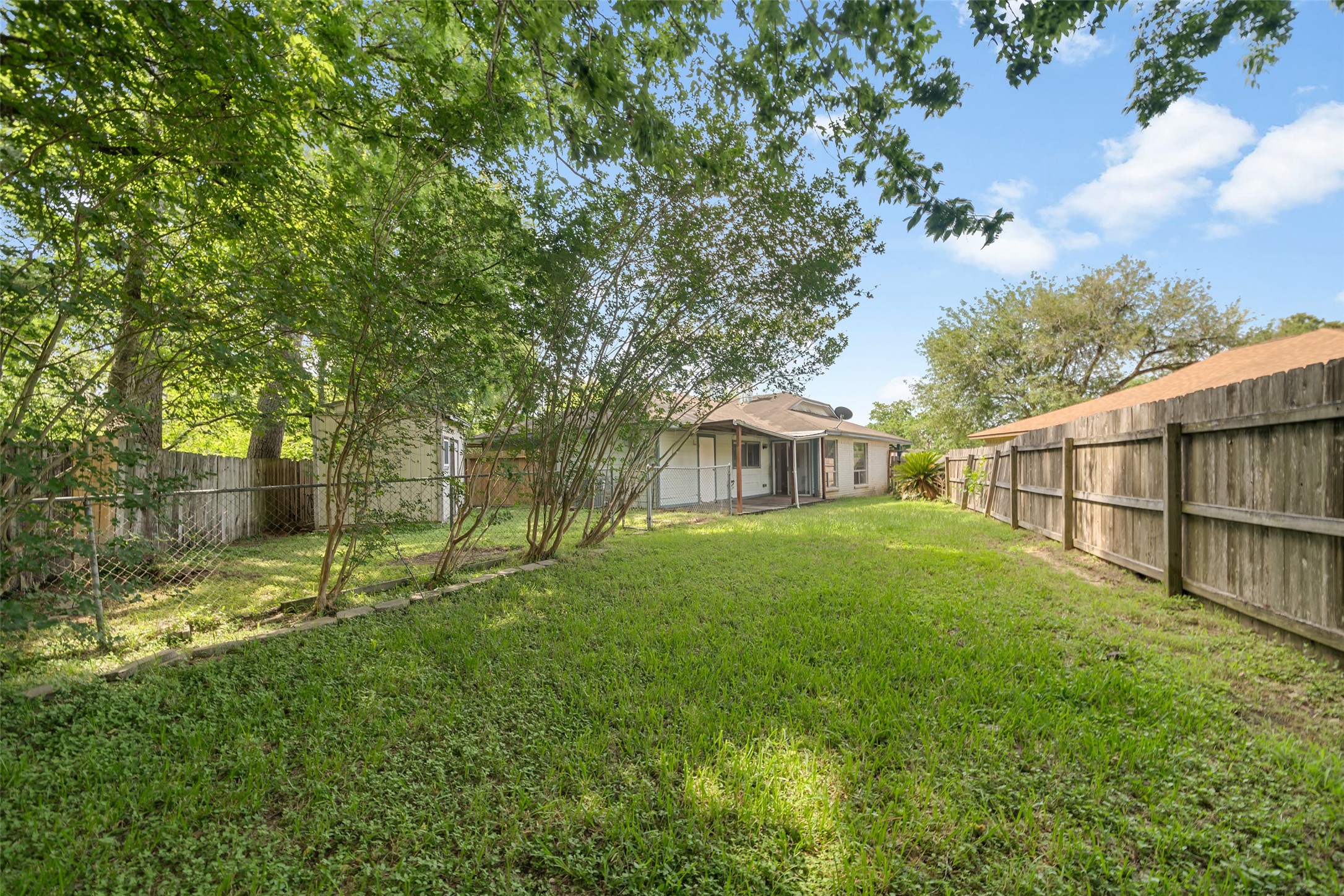3119 Oak Rock Spring, TX 77373 - Photo 18 of 25 a view of backyard with table and chairs and wooden fence