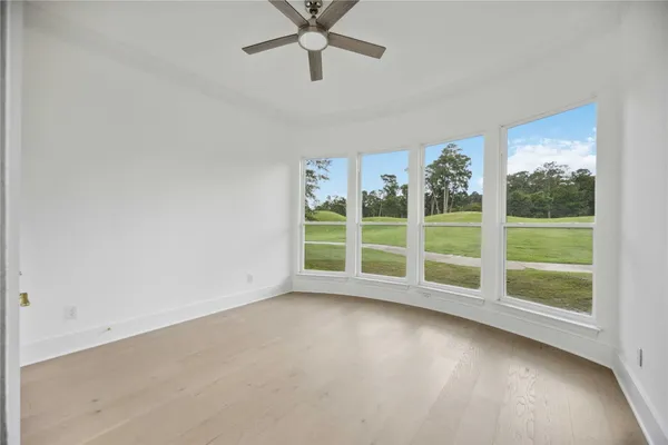 a view of a livingroom with wooden floor and a window