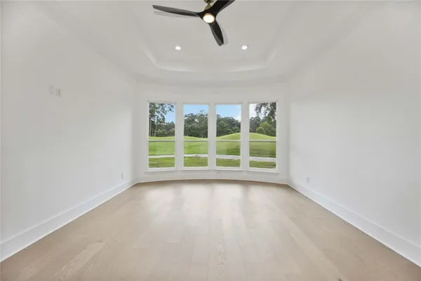 a view of a livingroom with wooden floor and a window