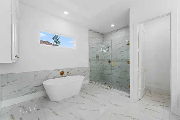 a bathroom with a bathtub and shower