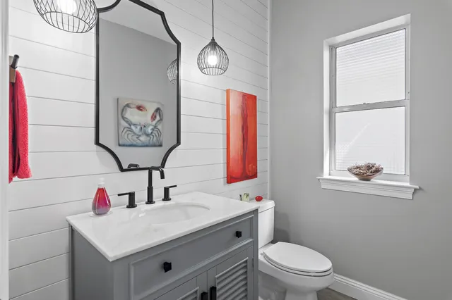 a bathroom with a toilet sink and mirror