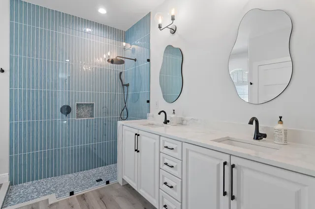 a bathroom with a sink double vanity and a mirror