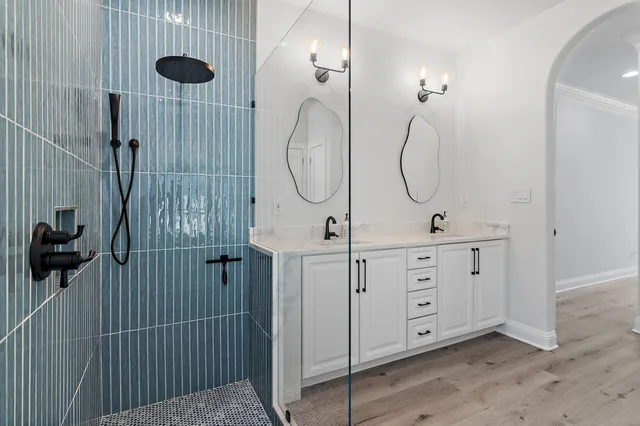 a bathroom with a double vanity sink and a mirror