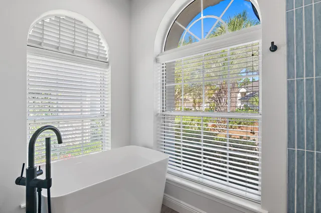 a bathroom with a bathtub and a window