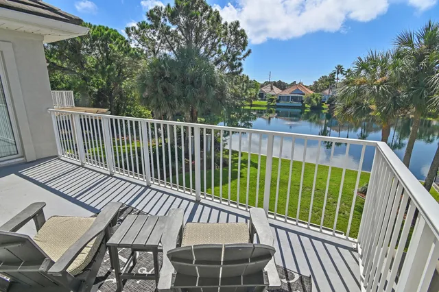 a view of balcony with wooden floor and fence