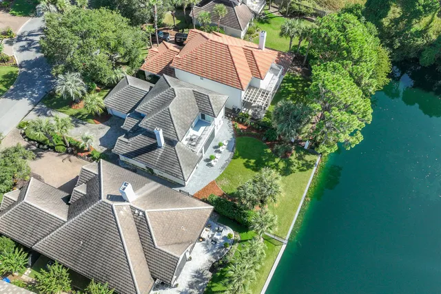 an aerial view of a house with garden space and street view