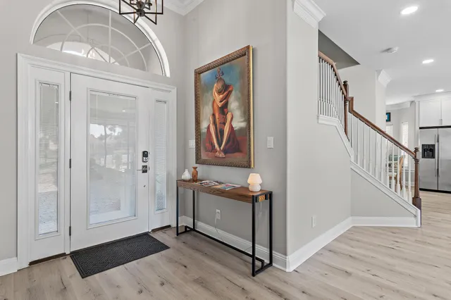 a view of a hallway with entryway wooden floor and front door