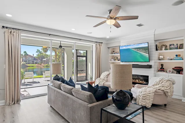 a living room with furniture a fireplace and a flat screen tv