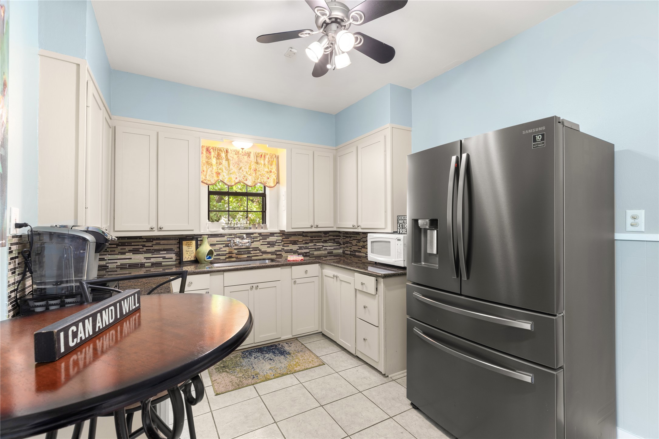 906 Higgins Street Humble, TX 77338 - Photo 11 of 26 This kitchen features light cabinetry, and a stylish tiled backsplash. It has a cozy breakfast nook and ample natural light from the window