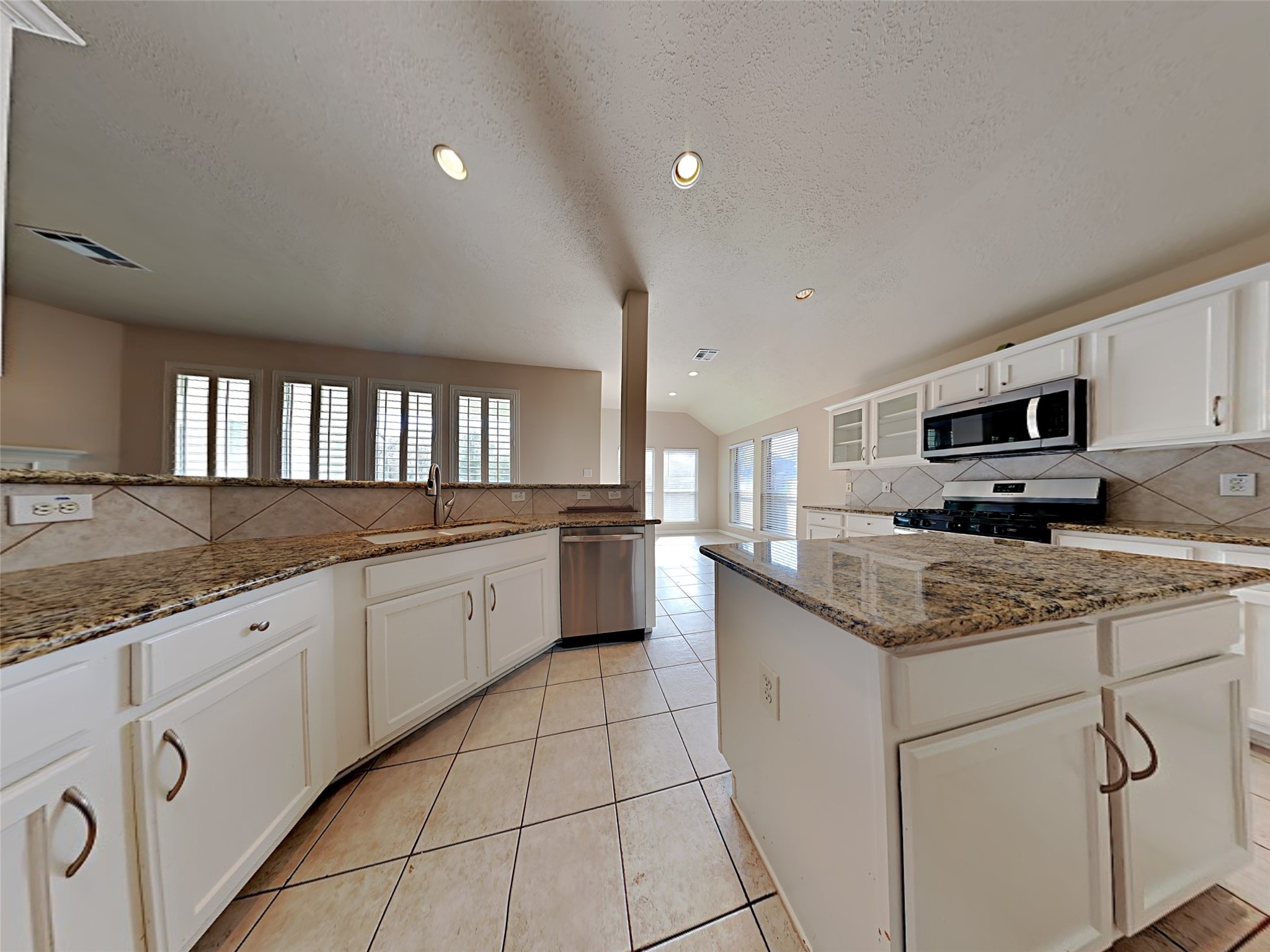 74 Wimberly Way Conroe, TX 77385 - Photo 11 of 18 a kitchen with granite countertop cabinets stainless steel appliances and a counter space