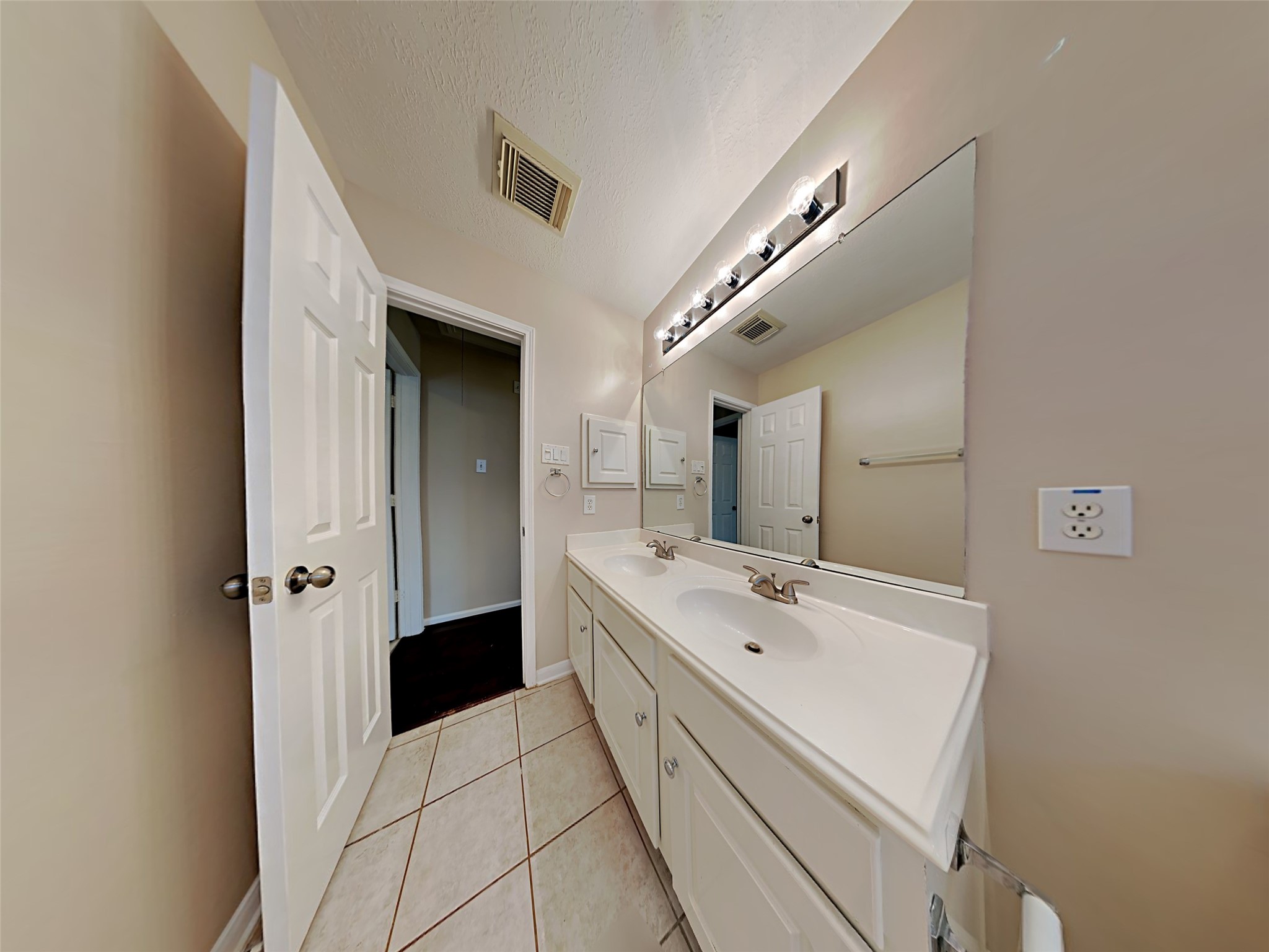74 Wimberly Way Conroe, TX 77385 - Photo 5 of 18 a bathroom with a double vanity sink and mirror
