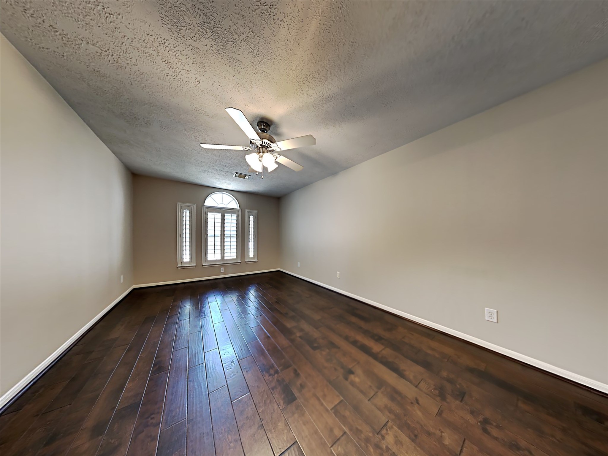74 Wimberly Way Conroe, TX 77385 - Photo 7 of 18 a view of an empty room with wooden floor and a window