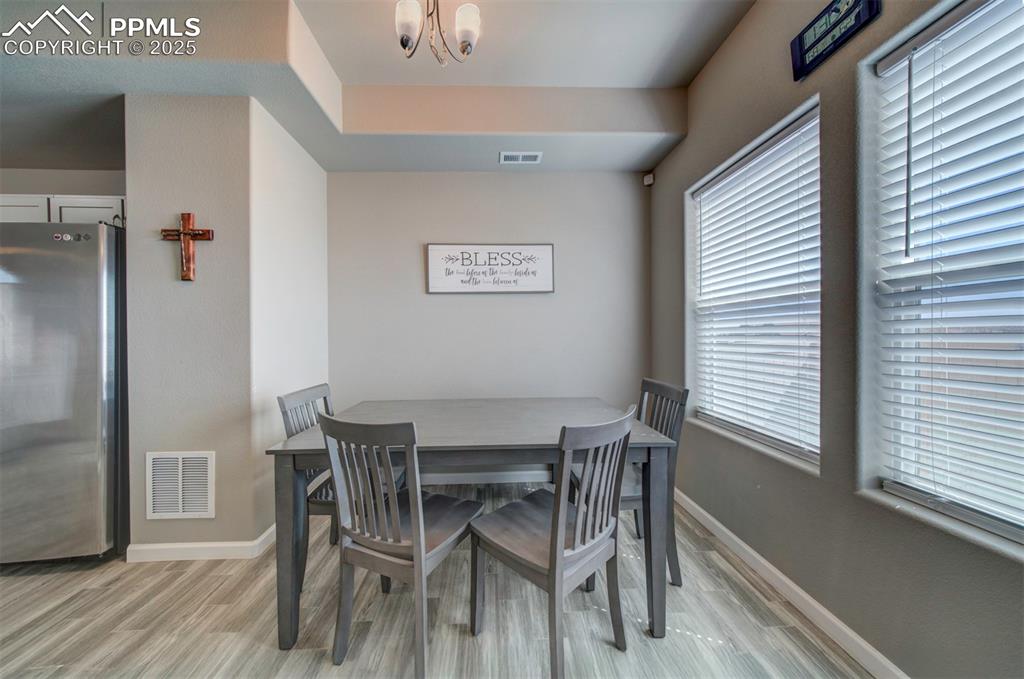 4151 Jericho Loop Colorado Springs, CO 80916 - Photo 17 of 34 a view of a dining room with furniture and wooden floor